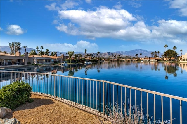 view of water feature featuring fence and a mountain view