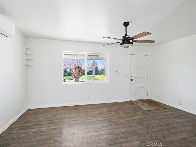 unfurnished room featuring ceiling fan, a wall mounted AC, baseboards, and wood finished floors