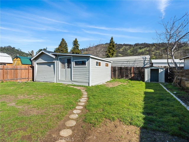 view of outdoor structure with an outdoor structure and a fenced backyard