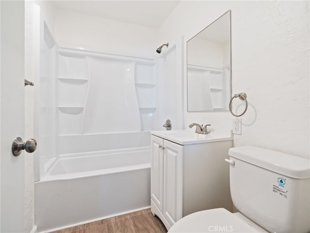 full bath featuring toilet, shower / bathtub combination, wood finished floors, and vanity