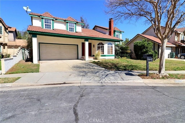 mediterranean / spanish-style home with a garage, concrete driveway, a tiled roof, and stucco siding