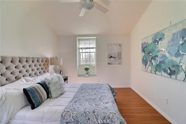 bedroom featuring wood finished floors, a ceiling fan, and baseboards