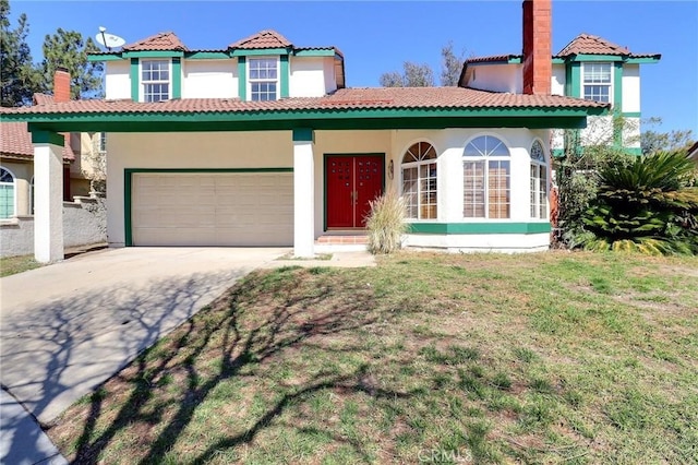 mediterranean / spanish house with a front lawn, concrete driveway, an attached garage, and stucco siding