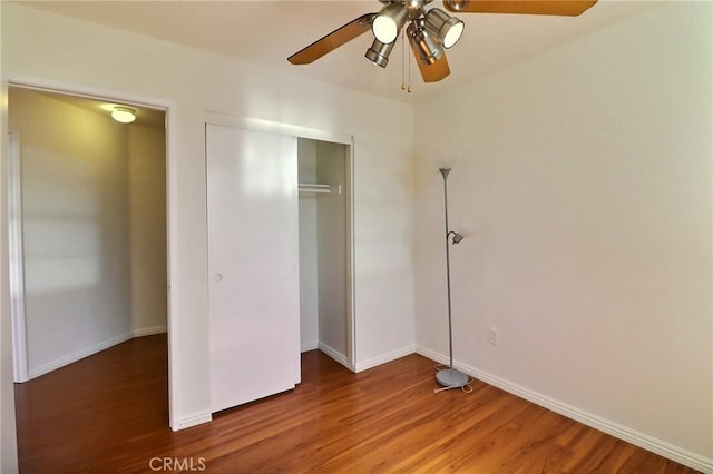 unfurnished bedroom with a ceiling fan, baseboards, and wood finished floors