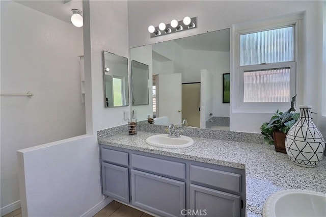 full bathroom with vanity and tile patterned floors