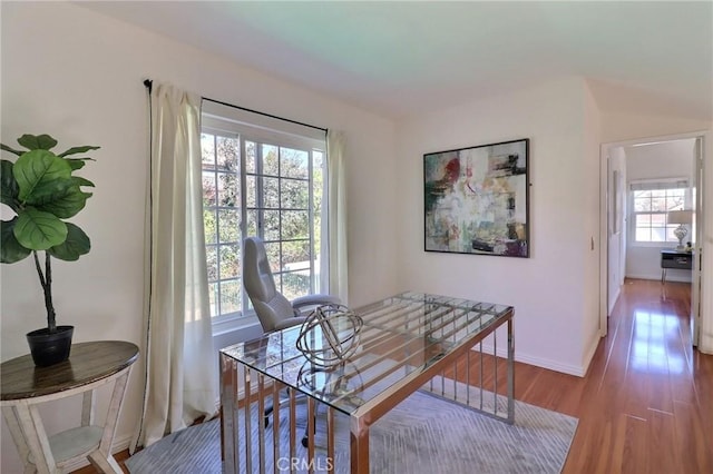 dining area with baseboards and wood finished floors