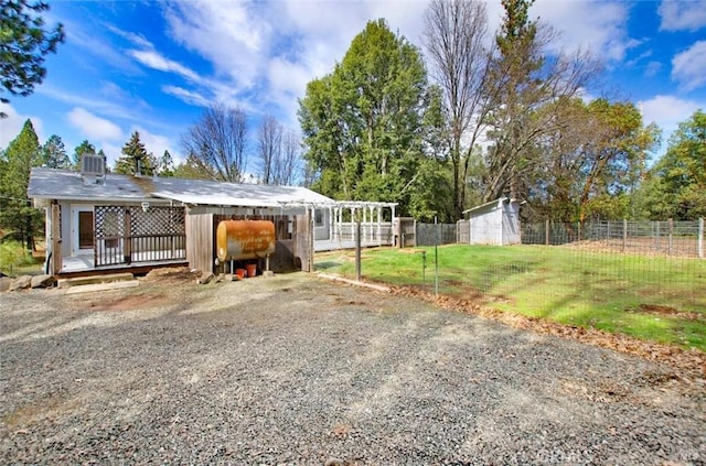 view of front of property featuring an outbuilding and fence