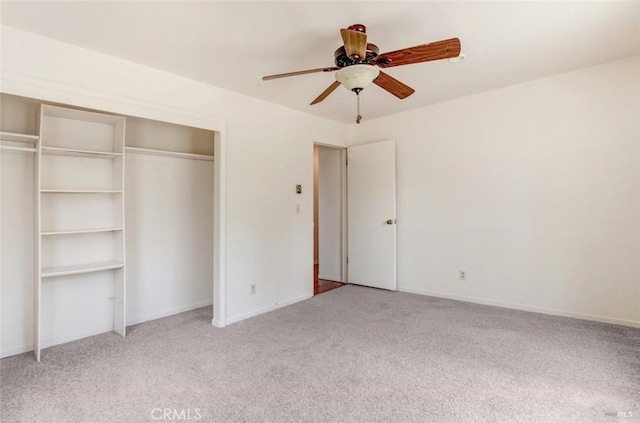 unfurnished bedroom featuring a closet, light colored carpet, and baseboards