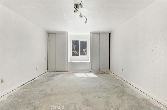 unfurnished room featuring unfinished concrete flooring