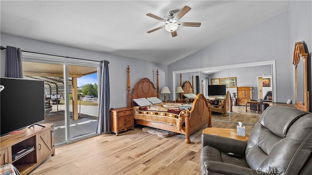 bedroom featuring a ceiling fan, light wood-style flooring, vaulted ceiling, and access to outside