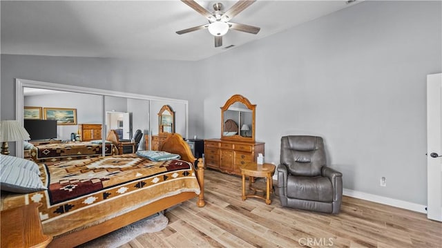 bedroom with visible vents, baseboards, wood finished floors, and vaulted ceiling