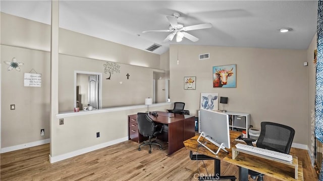 office area with a ceiling fan, lofted ceiling, wood finished floors, and baseboards