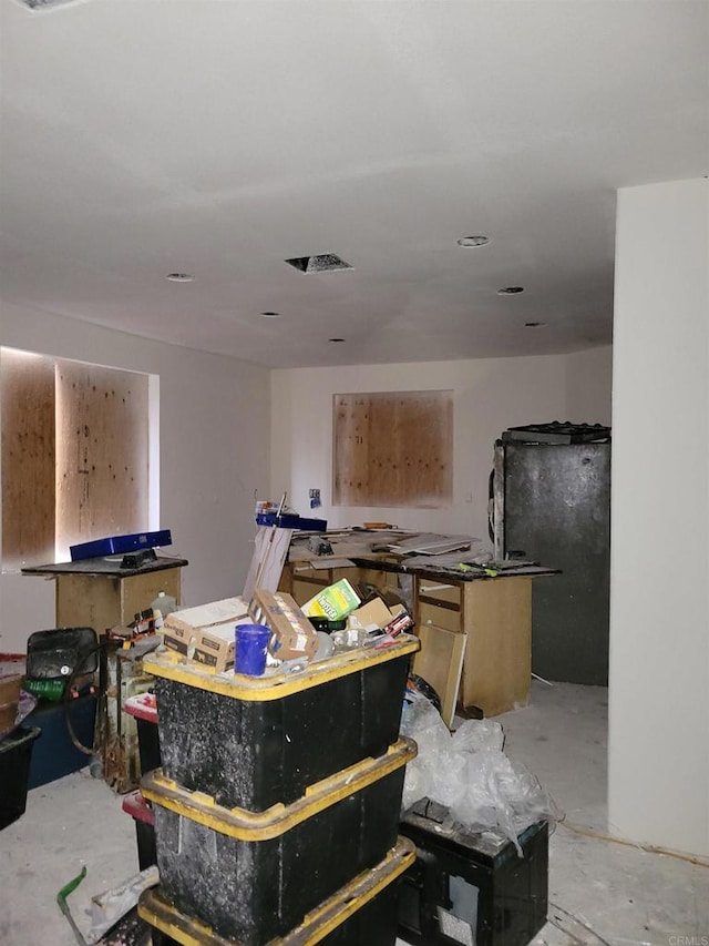 miscellaneous room featuring unfinished concrete flooring and visible vents