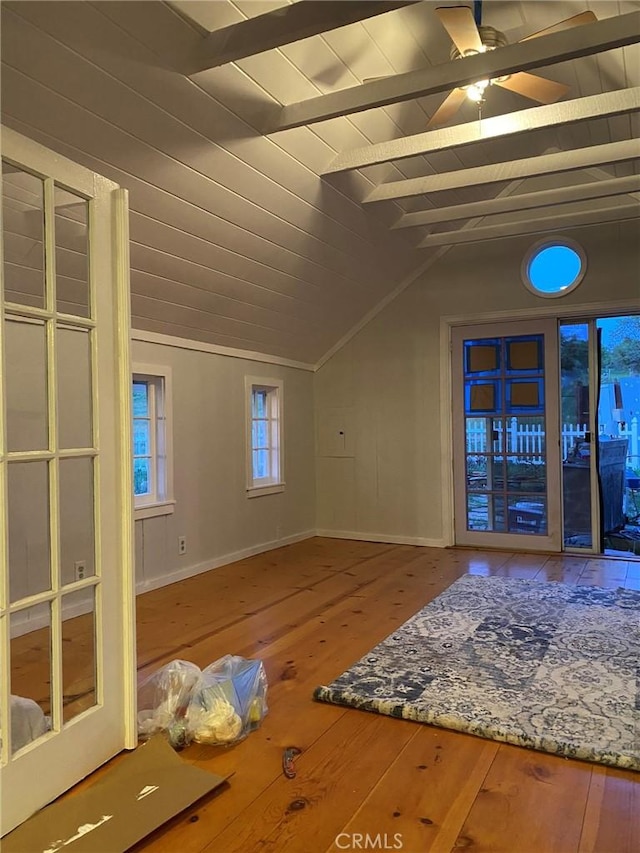 unfurnished living room featuring baseboards, ceiling fan, wood ceiling, hardwood / wood-style floors, and vaulted ceiling