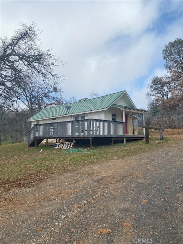 view of front facade with a deck and metal roof
