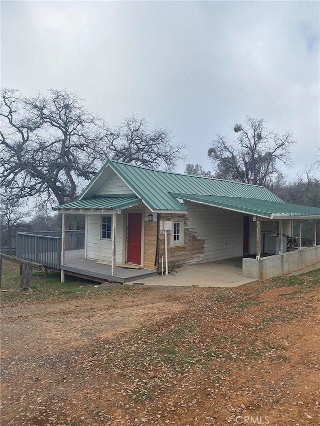 view of front of house with a carport and metal roof