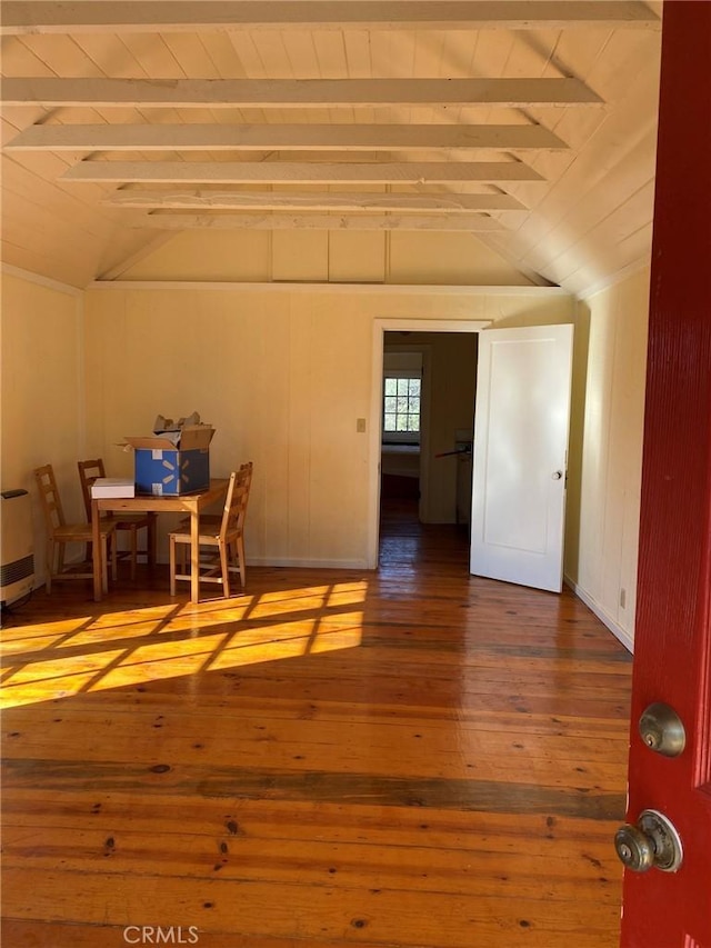 interior space featuring lofted ceiling with beams and hardwood / wood-style floors