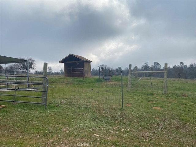 view of yard with a rural view and an outbuilding