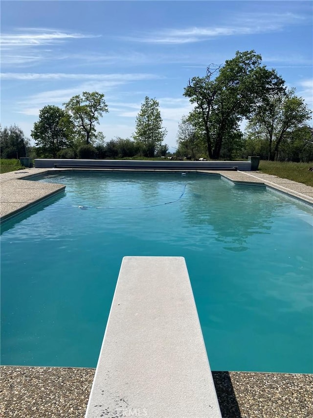 outdoor pool featuring a diving board