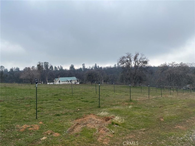 view of yard featuring a rural view and fence