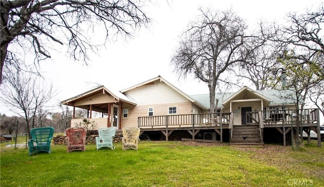 rear view of house with a lawn and a deck