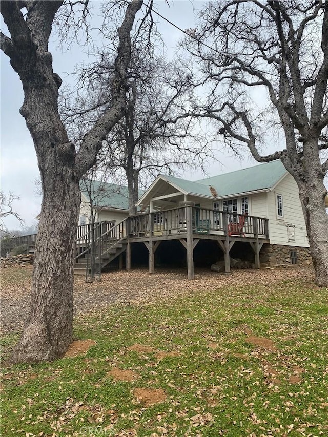 back of house with stairs and a deck