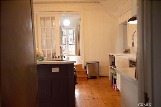 interior space featuring light wood finished floors and stainless steel microwave