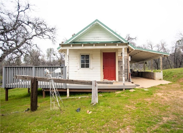 back of property featuring a lawn and a wooden deck