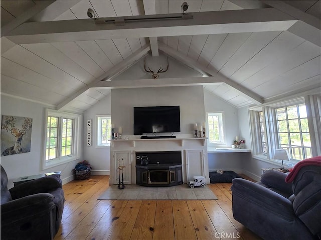 living room with wood-type flooring, baseboards, and vaulted ceiling with beams