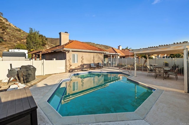 view of swimming pool with a fenced in pool, a fenced backyard, and a patio