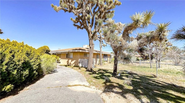 view of front of house featuring fence and stucco siding