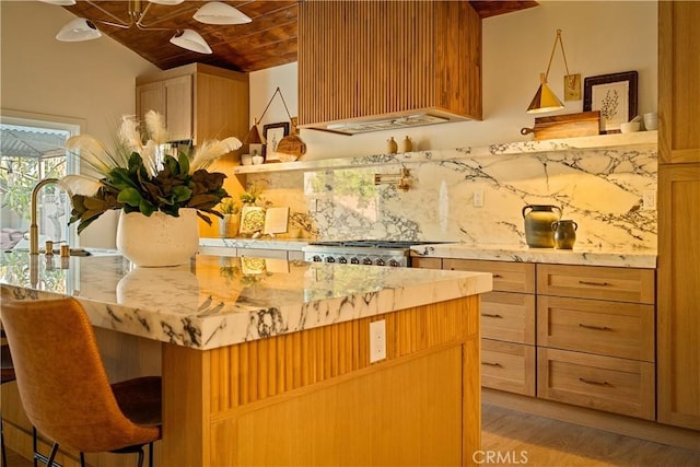 kitchen with light stone countertops, a sink, decorative backsplash, wood ceiling, and range