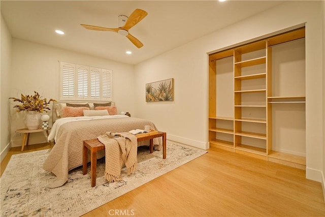 bedroom with recessed lighting, ceiling fan, baseboards, and wood finished floors