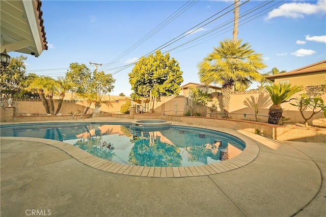 view of pool with a patio, a fenced backyard, and a pool with connected hot tub