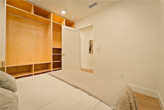 bedroom featuring recessed lighting, visible vents, baseboards, and wood finished floors