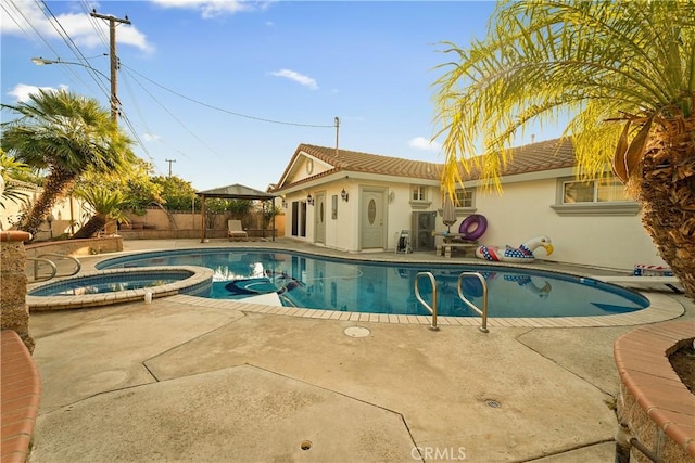 view of pool featuring a gazebo, a patio area, fence, and a pool with connected hot tub