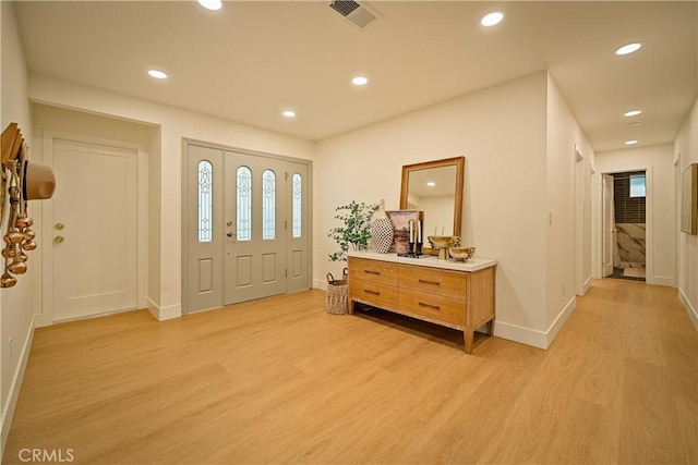 foyer entrance featuring light wood-style flooring, recessed lighting, visible vents, and baseboards