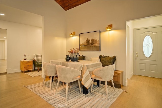 dining room featuring light wood-type flooring and baseboards