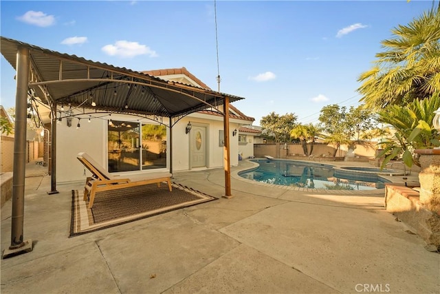 view of pool with a fenced backyard, a gazebo, a fenced in pool, an in ground hot tub, and a patio area