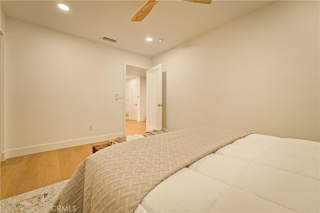 bedroom featuring recessed lighting, baseboards, wood finished floors, and a ceiling fan