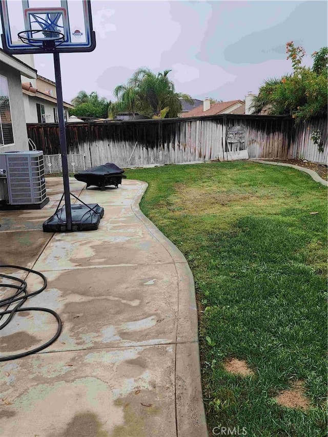 view of yard featuring a patio area, a fenced backyard, and central air condition unit