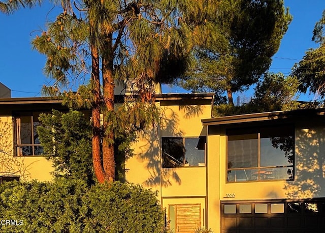 view of home's exterior featuring a garage and stucco siding