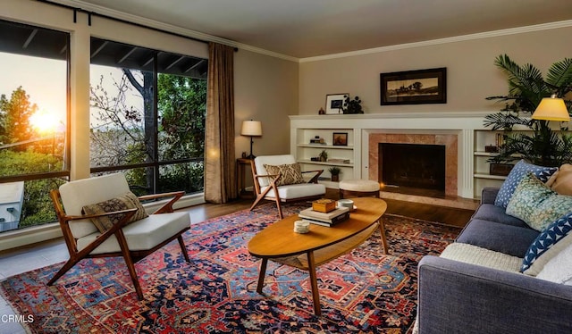 living area featuring ornamental molding, a premium fireplace, and wood finished floors