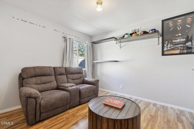 living area featuring wood finished floors and baseboards