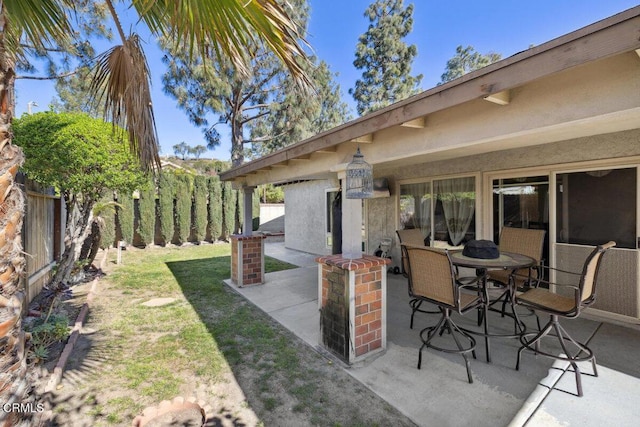 view of patio featuring fence and outdoor dining space