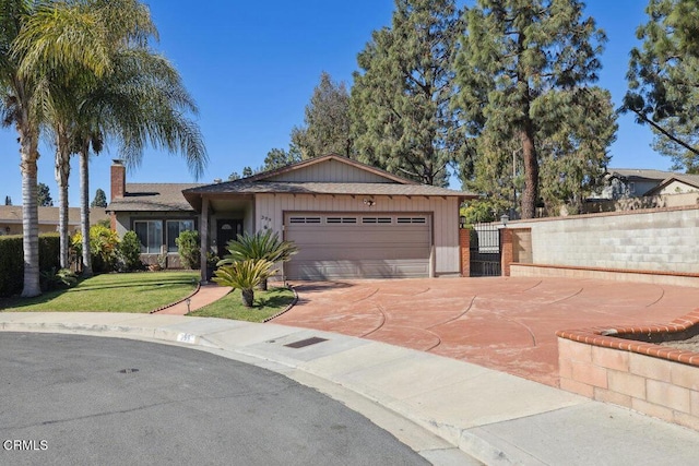 ranch-style house with a garage, driveway, a front lawn, and fence