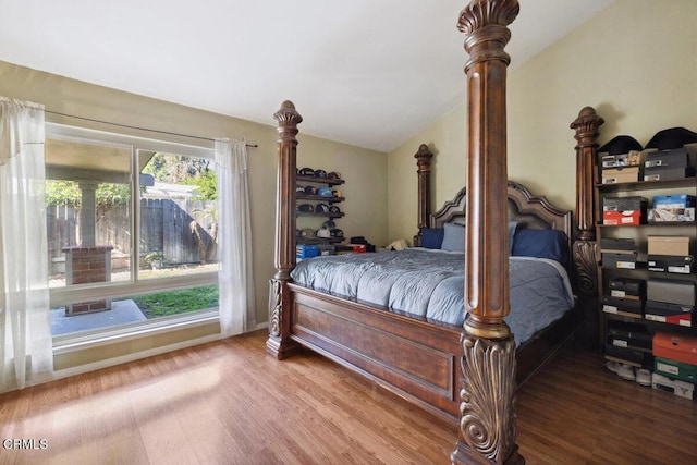 bedroom featuring vaulted ceiling and wood finished floors