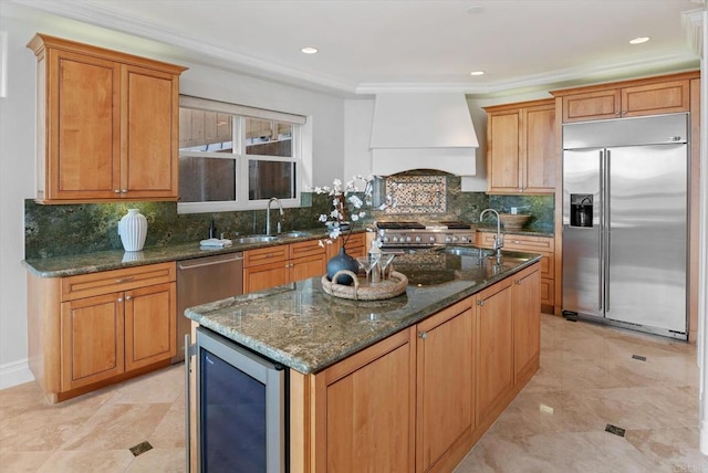 kitchen with appliances with stainless steel finishes, beverage cooler, a sink, and custom exhaust hood