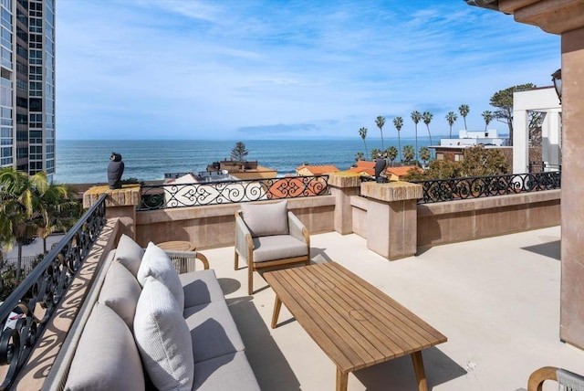 view of patio with an outdoor hangout area, a water view, and a balcony