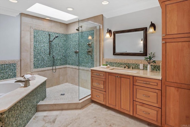 bathroom with a skylight, vanity, a garden tub, and a stall shower